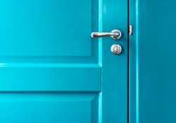 Teal door with silver handle.