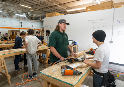 people working at tables with tools