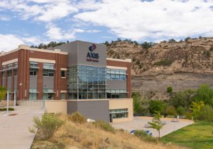 The exterior of the Axis building with brown hills in background